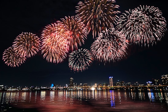 fireworks display over the city during night time