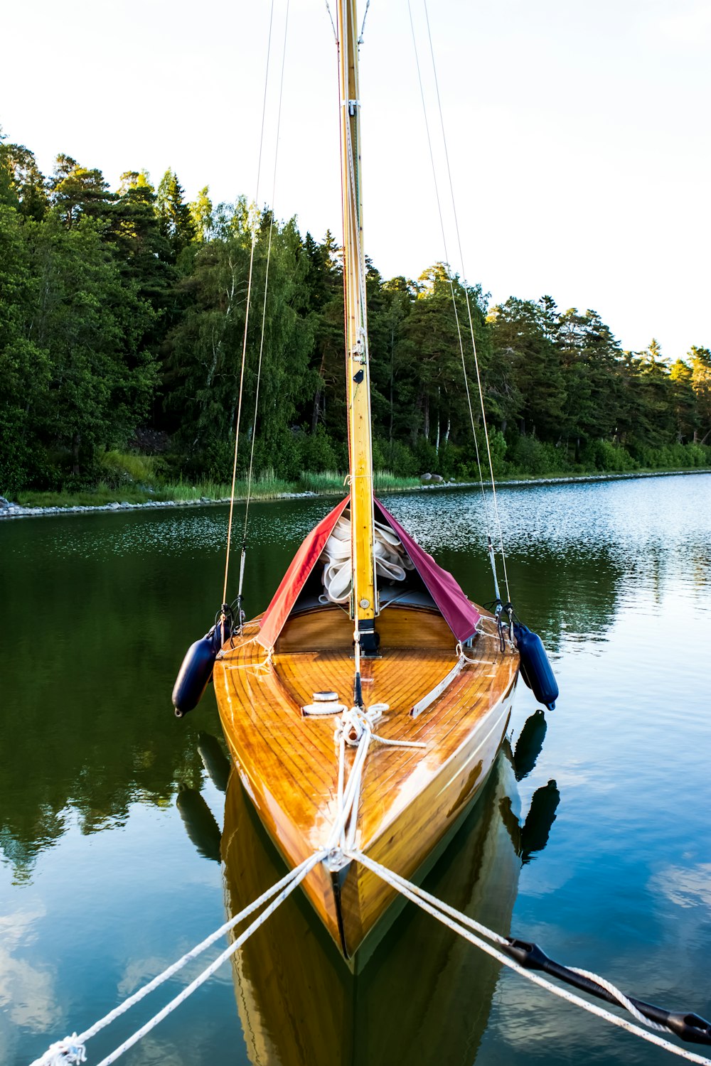 brown boat on lake during daytime