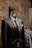black suit jacket near brown brick wall