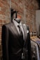 black suit jacket near brown brick wall