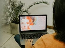 woman in yellow long sleeve shirt using macbook pro