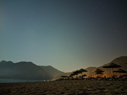 brown and white tent on beach during night time in Çıralı Beach Turkey