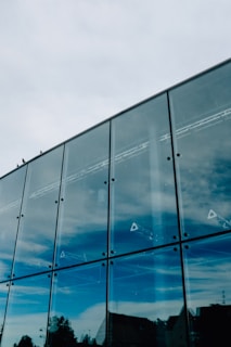 Front view of Birds Electromechanical's sleek office building against a clear blue sky.