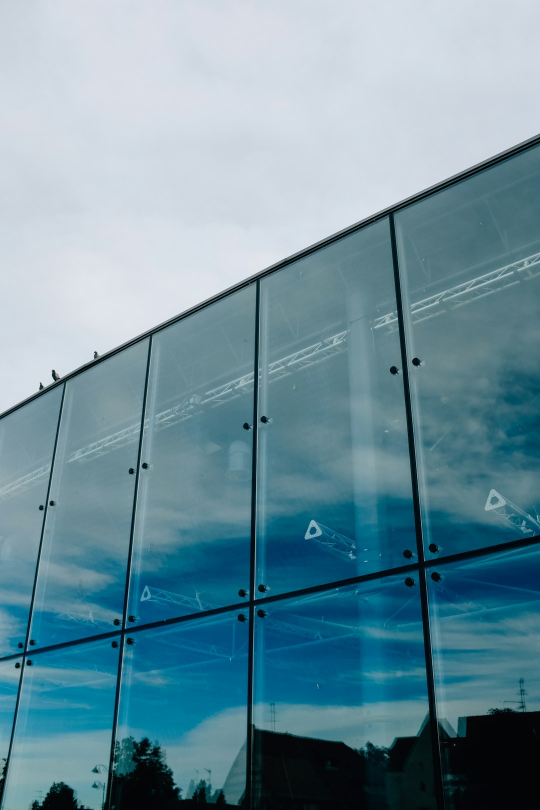 blue and white glass walled building under blue sky