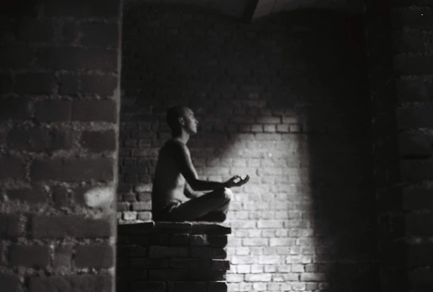 A serene person meditating with glowing human design charts floating around them in a mystical space.