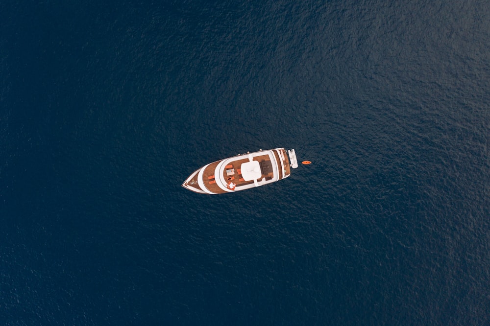 white and red boat on body of water during daytime