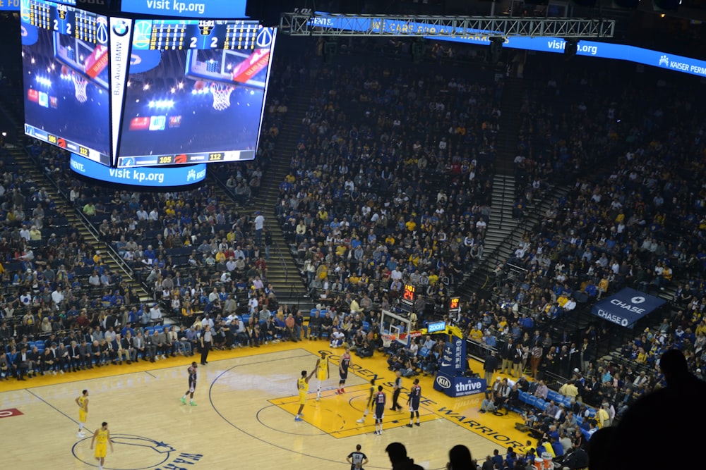 people watching basketball game on stadium