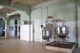 Close-up of industrial mixers and grinders in a busy food processing area