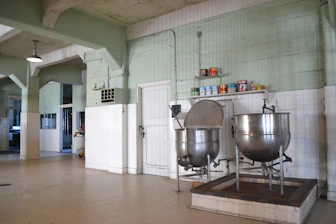 Close-up of industrial mixers and grinders in a busy food processing area