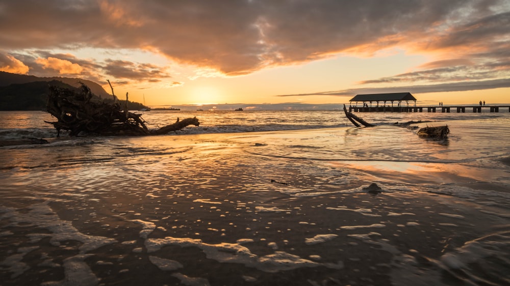 silhouette of boat on sea during sunset