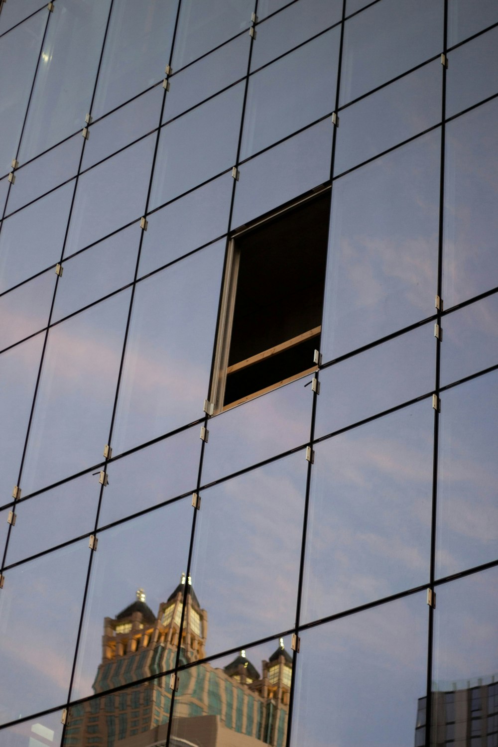 black framed glass window on blue concrete building