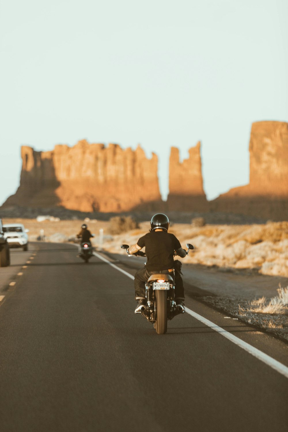 man in black jacket riding motorcycle on road during daytime