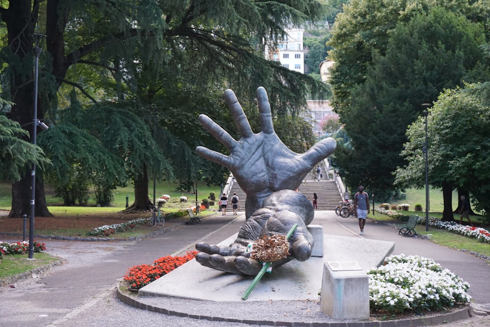 gray concrete statue near green trees during daytime