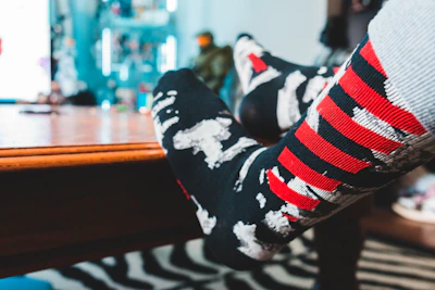 Close-up of colorful casual socks laid out on a wooden table.