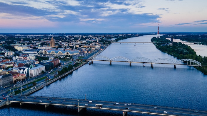 aerial view of city buildings near body of water during daytime