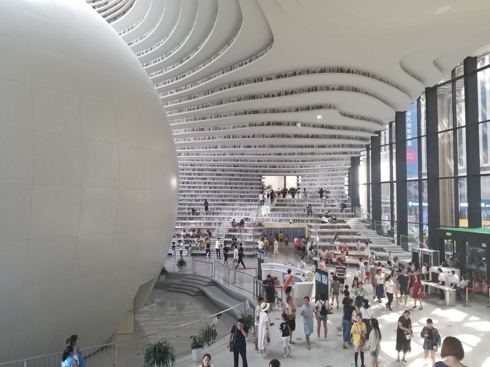 people walking on white concrete building during daytime