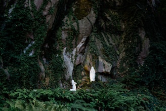 Saint Bernadette Soubirous kneeling before the Blessed Virgin Mary at the Grotto in Lourdes, France,
