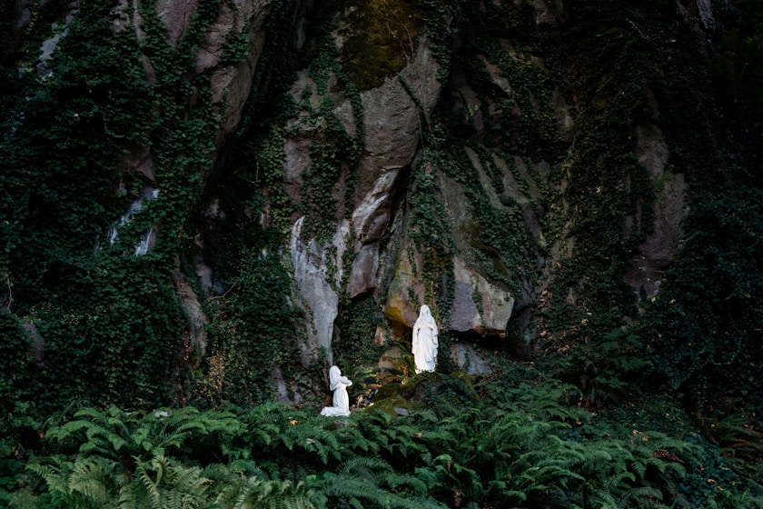Saint Bernadette Soubirous kneeling before the Blessed Virgin Mary at the Grotto in Lourdes, France,