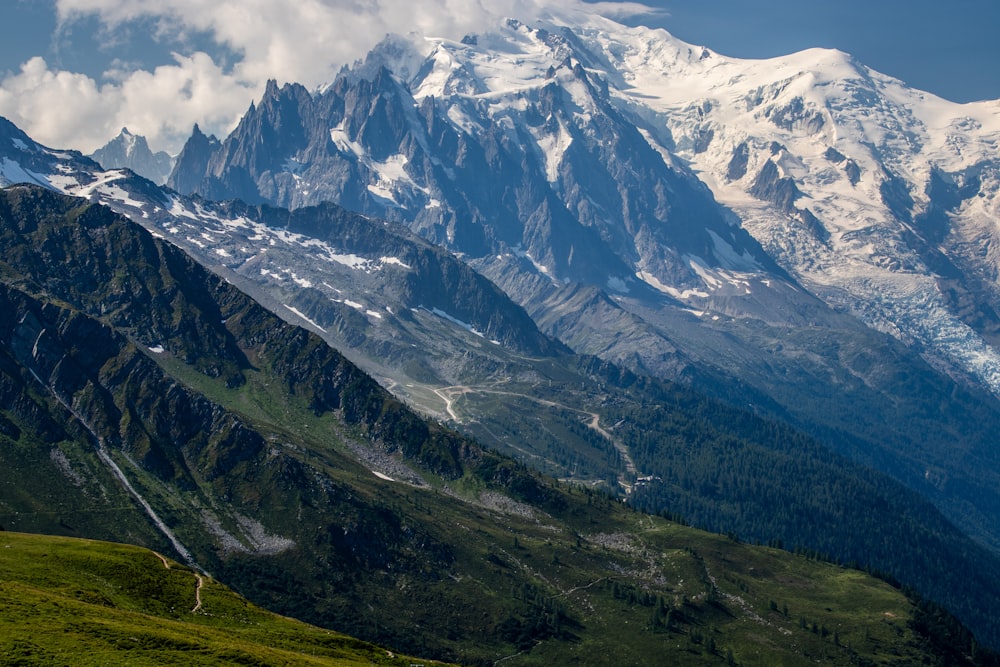 green and white mountains under white clouds during daytime