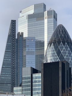 white and blue glass walled high rise building