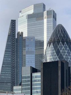 white and blue glass walled high rise building
