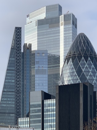 white and blue glass walled high rise building