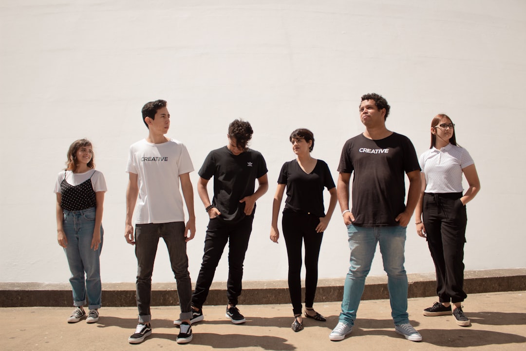 group of people standing on brown floor,