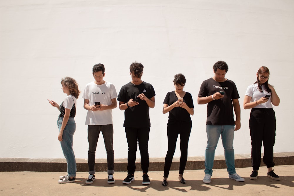 group of people standing on brown floor