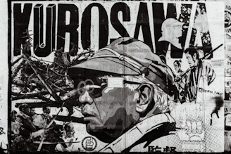 grayscale photo of man in black and white shirt