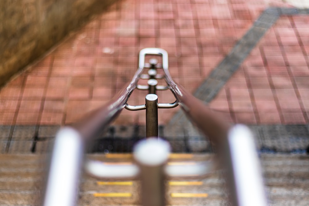 stainless steel railings on brown brick floor