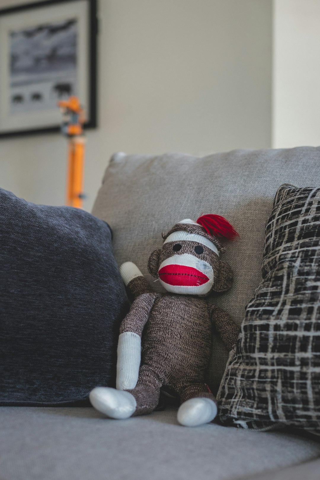 gray and white plush toy on gray sofa