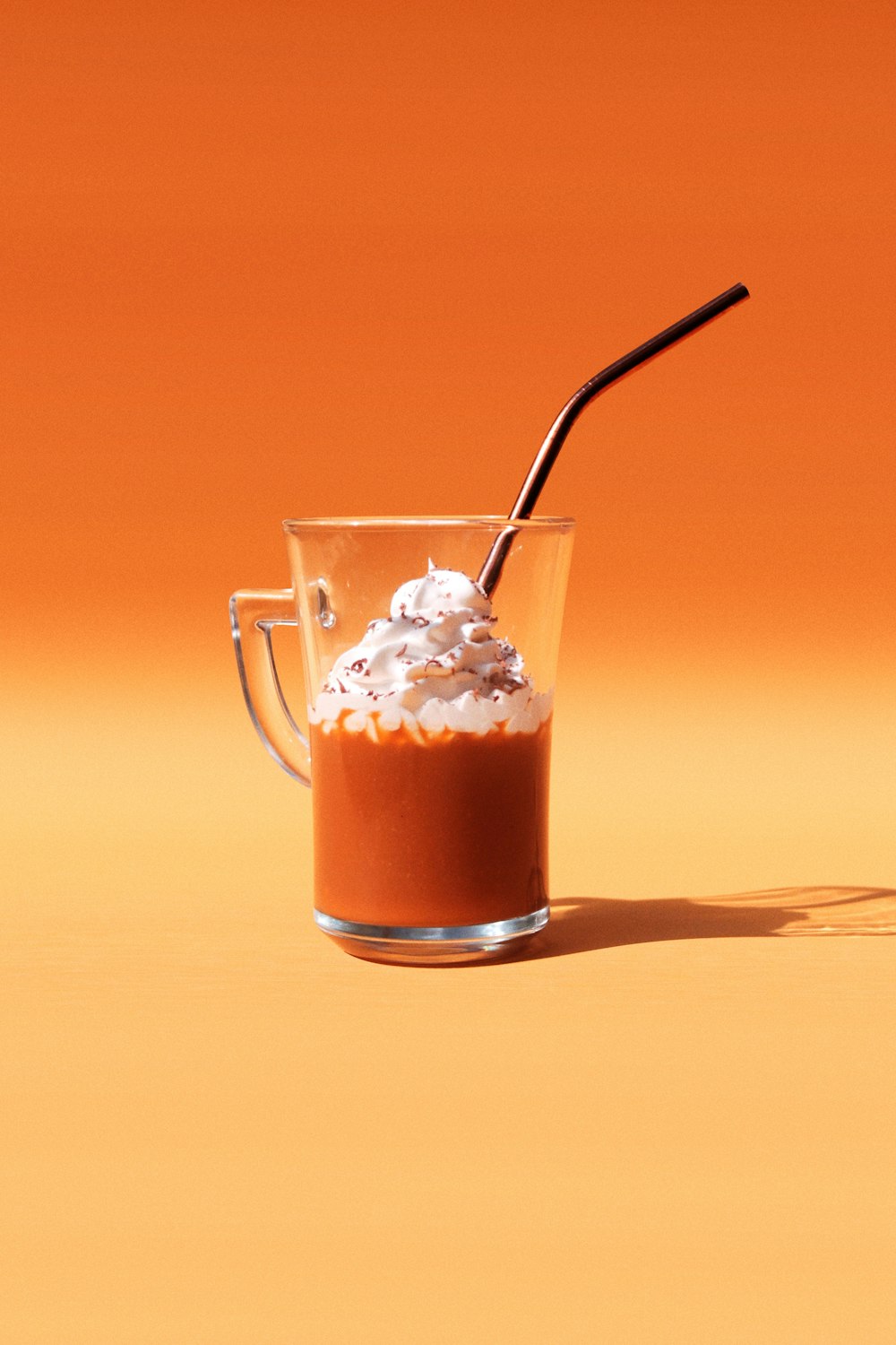 clear glass mug with brown liquid