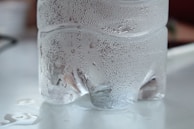 A 1.5-liter Água Mineral Croatá bottle with droplets of condensation on the surface.