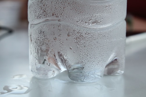 Close-up of pure bottled water with condensation droplets.