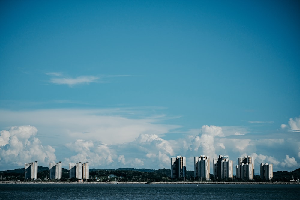 city skyline across body of water during daytime