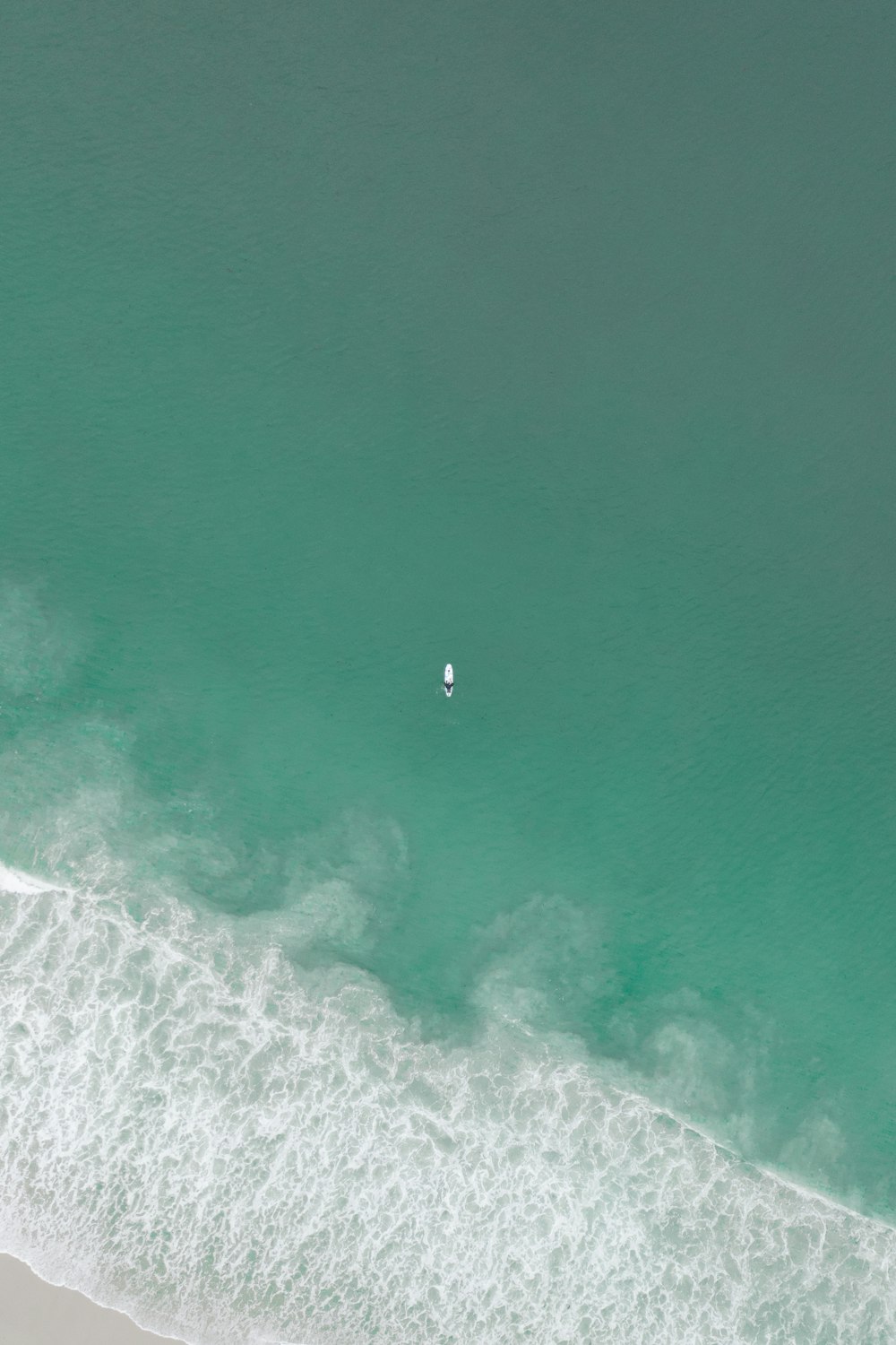 aerial view of person surfing on sea waves during daytime