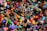A chaotic assortment of colorful toys piled together, including action figures, plush animals, vehicles, and various shapes and characters. The variety of toys suggests a playful and imaginative setting.