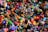 A chaotic assortment of colorful toys piled together, including action figures, plush animals, vehicles, and various shapes and characters. The variety of toys suggests a playful and imaginative setting.