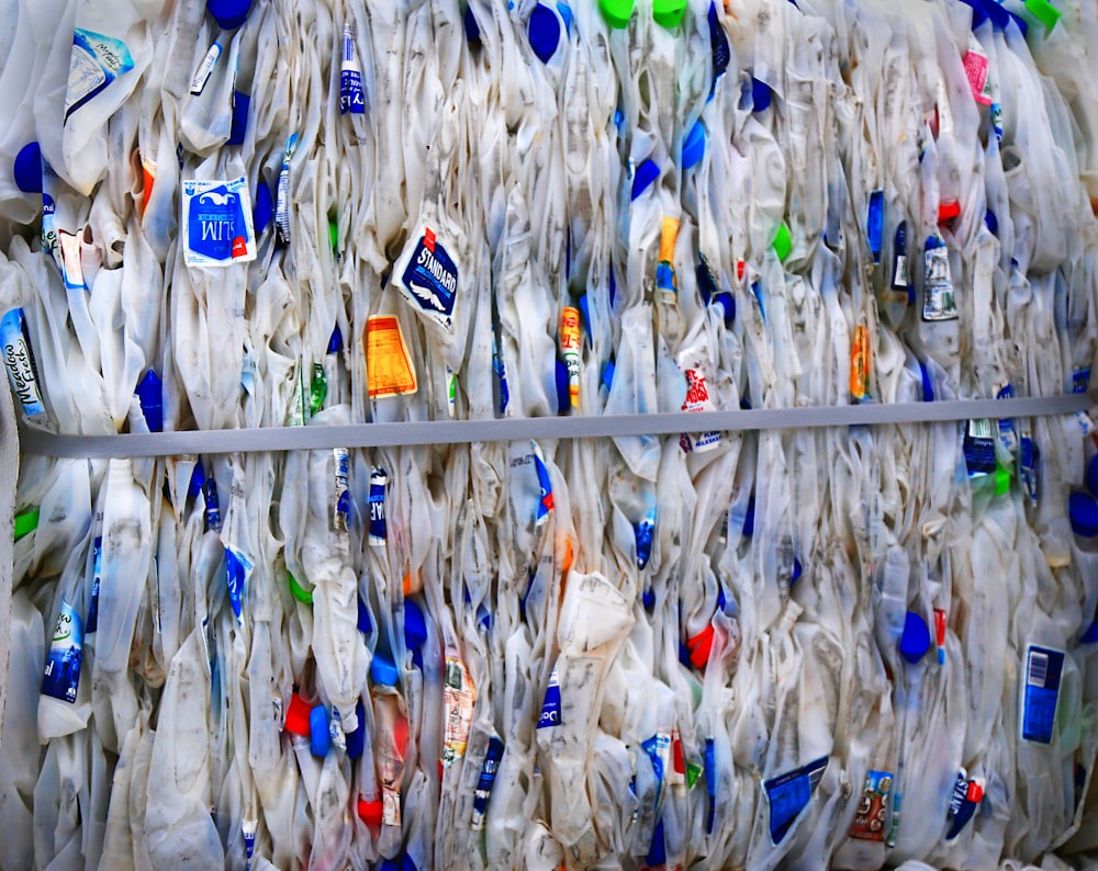 blue and yellow plastic pack on white wooden fence