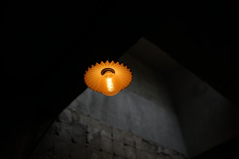 orange jack o lantern on brown brick wall