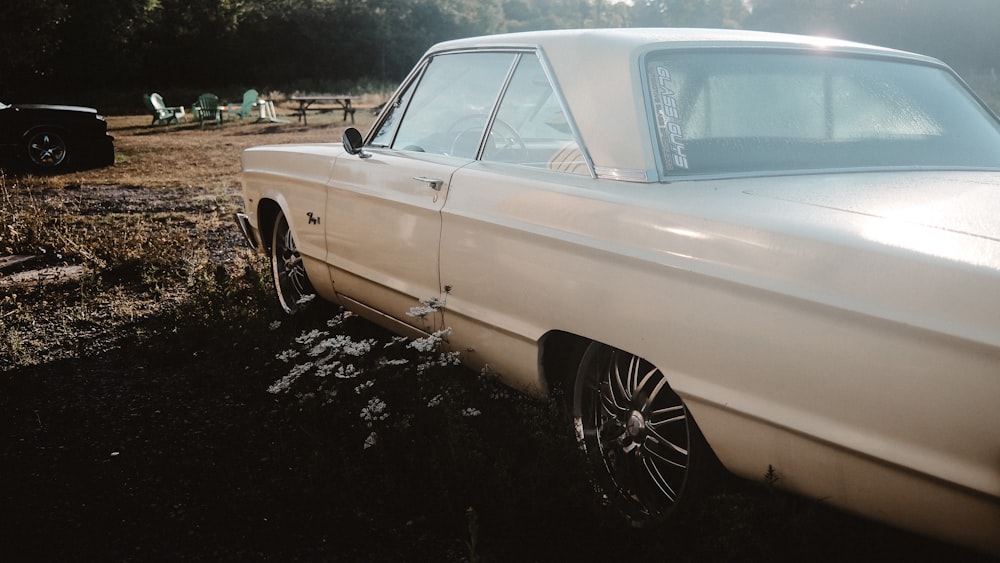 white coupe on black soil