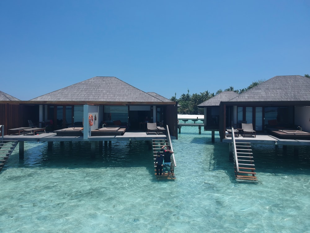 brown wooden house on body of water during daytime