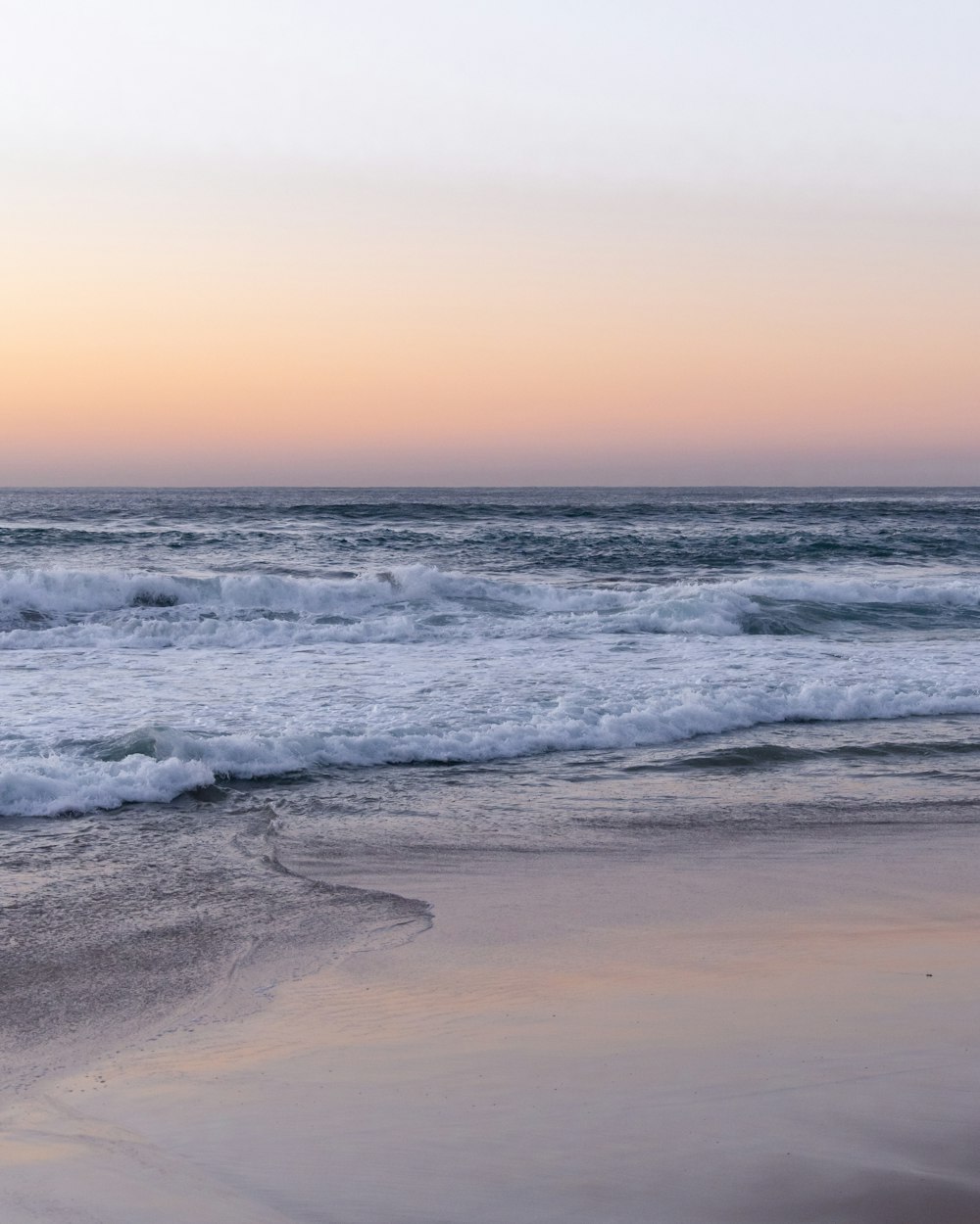 ocean waves crashing on shore during daytime