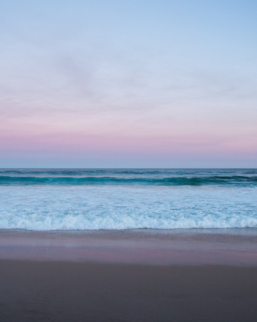 ocean waves crashing on shore during daytime