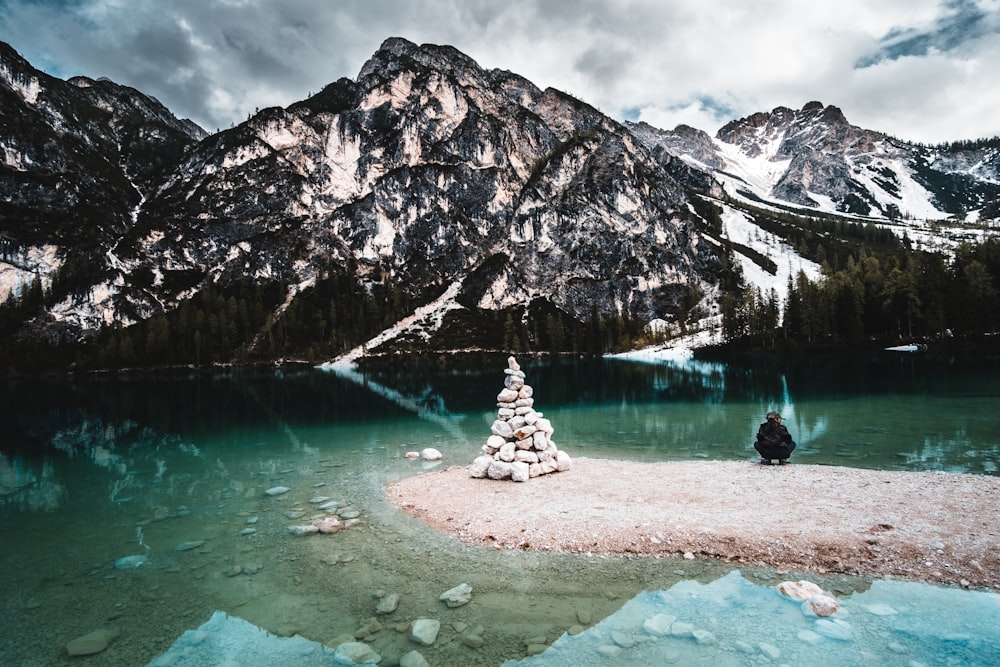 white and brown mountain near body of water during daytime