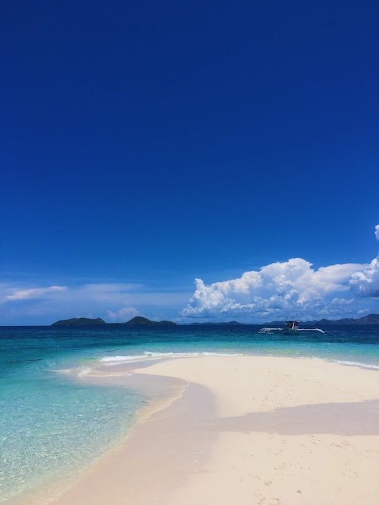 white clouds over blue sea in Coron Island Philippines