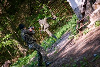 Operators moving stealthily through a forested training ground.