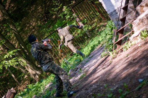 Operators moving stealthily through a forested training ground.