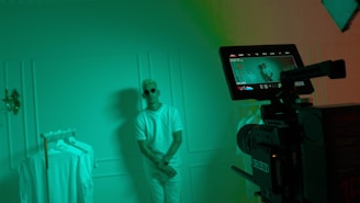 Backstage moment capturing the quiet focus of the runway director amidst soft shadows and minimalist decor.