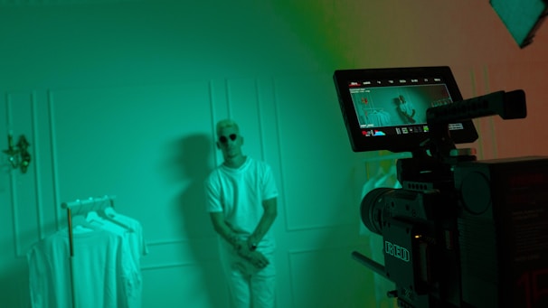 Backstage moment capturing the quiet focus of the runway director amidst soft shadows and minimalist decor.